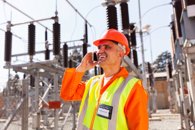 energy contractor on phone and happy after receiving an on the job reward